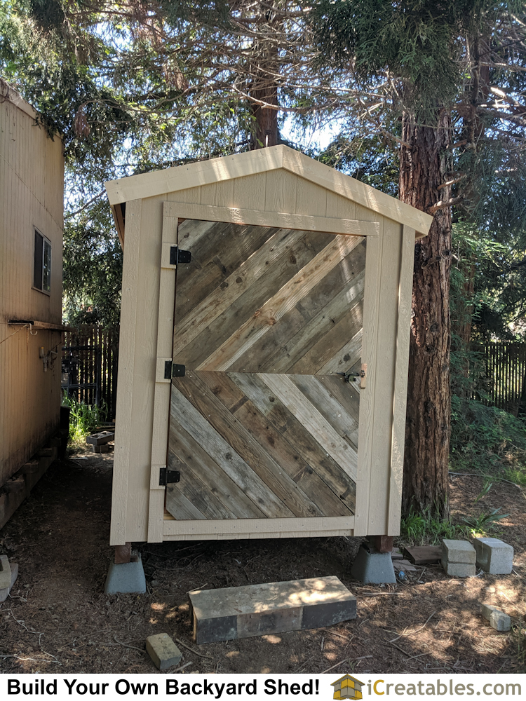 Backyard storage shed plans with custom barn wood door.