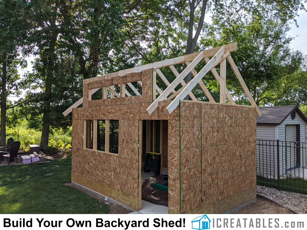 Roof framing of ridge beam and rafters for stick built roof on dormer shed design.