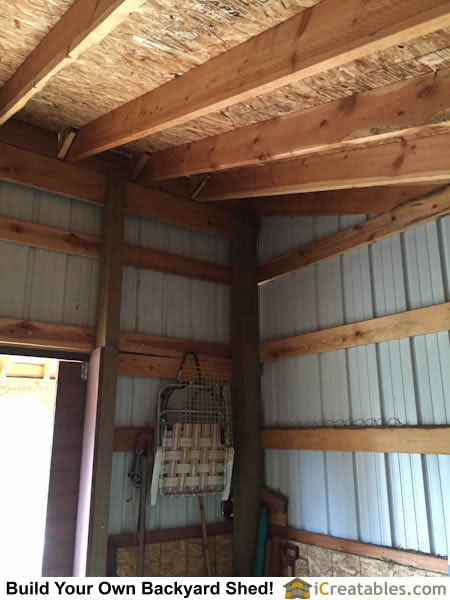 Interior roof and wall framing girt boards of horse barn.